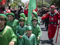 Iraqi men and children living in Iran are performing in a religious festival to commemorate Ashura in the Dolatabad neighborhood in southern...