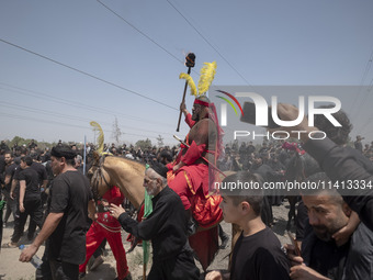 An Iraqi man living in Iran is riding a horse while performing in a religious festival to commemorate Ashura in the Dolatabad neighborhood i...