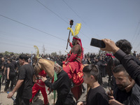 An Iraqi man living in Iran is riding a horse while performing in a religious festival to commemorate Ashura in the Dolatabad neighborhood i...