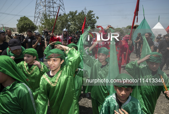 Iraqi men and children living in Iran are performing in a religious festival to commemorate Ashura in the Dolatabad neighborhood in southern...