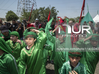 Iraqi men and children living in Iran are performing in a religious festival to commemorate Ashura in the Dolatabad neighborhood in southern...