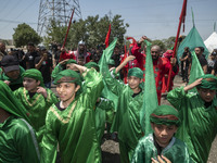 Iraqi men and children living in Iran are performing in a religious festival to commemorate Ashura in the Dolatabad neighborhood in southern...