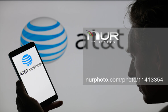 The AT&T logo is being displayed on a smartphone with AT&T visible in the background in this photo illustration in Brussels, Belgium, on Jul...