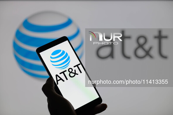 The AT&T logo is being displayed on a smartphone with AT&T visible in the background in this photo illustration in Brussels, Belgium, on Jul...