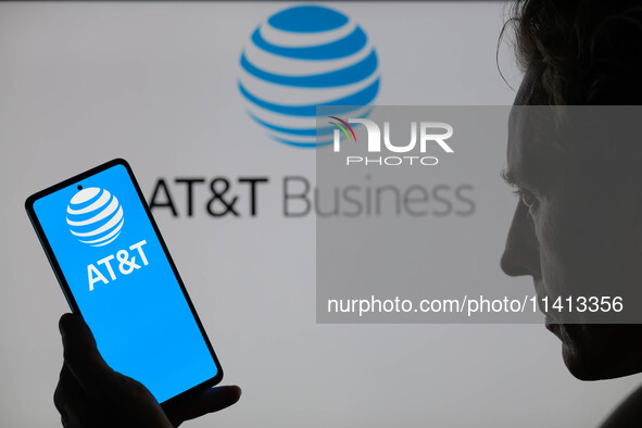 The AT&T logo is being displayed on a smartphone with AT&T visible in the background in this photo illustration in Brussels, Belgium, on Jul...