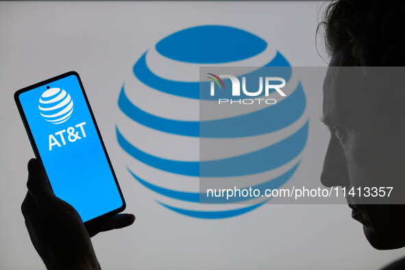 The AT&T logo is being displayed on a smartphone with the AT&T icon in the background in this photo illustration in Brussels, Belgium, on Ju...