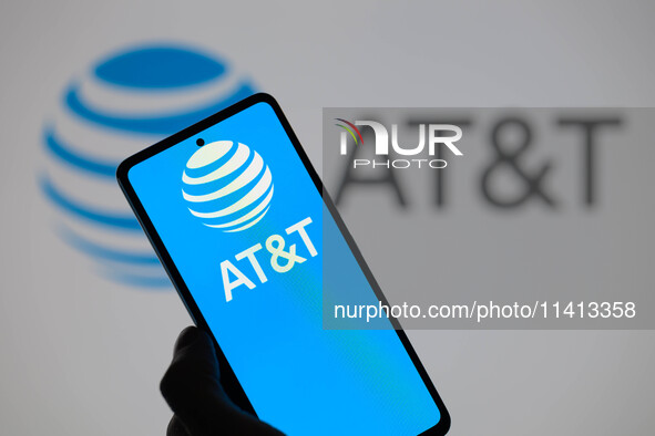 The AT&T logo is being displayed on a smartphone with AT&T visible in the background in this photo illustration in Brussels, Belgium, on Jul...