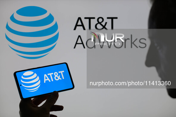 The AT&T logo is being displayed on a smartphone with AT&T visible in the background in this photo illustration in Brussels, Belgium, on Jul...