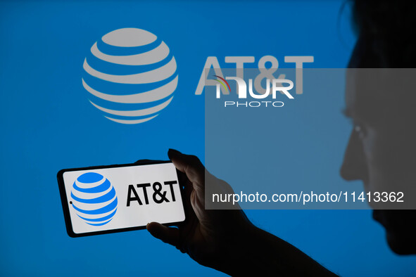 The AT&T logo is being displayed on a smartphone with AT&T visible in the background in this photo illustration in Brussels, Belgium, on Jul...