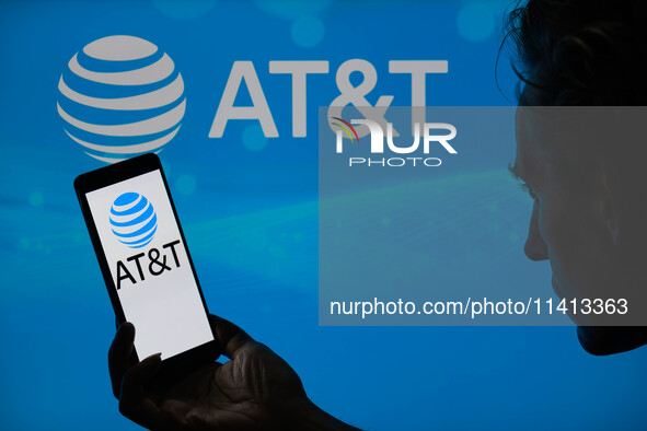 The AT&T logo is being displayed on a smartphone with AT&T visible in the background in this photo illustration in Brussels, Belgium, on Jul...