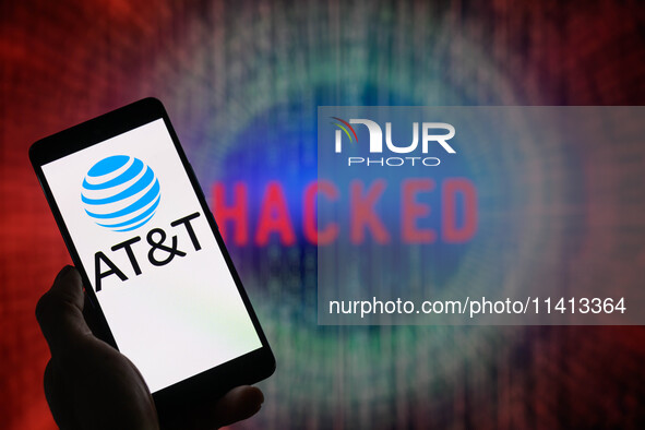 The AT&T logo is being displayed on a smartphone with ''hacked'' visible in the background in this photo illustration in Brussels, Belgium,...