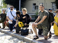 People are attending a funeral service for Mykola Kokhanivskyi, commander of the OUN (Organisation of Ukrainian Nationalists) volunteer batt...