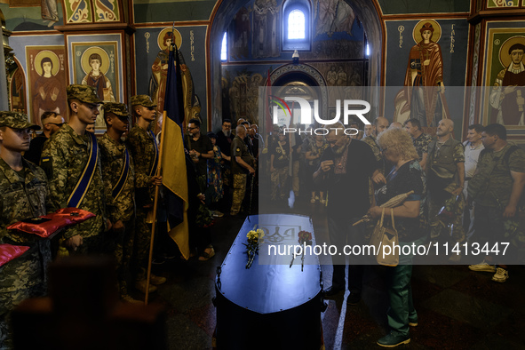 People are attending a funeral service for Mykola Kokhanivskyi, commander of the OUN (Organisation of Ukrainian Nationalists) volunteer batt...