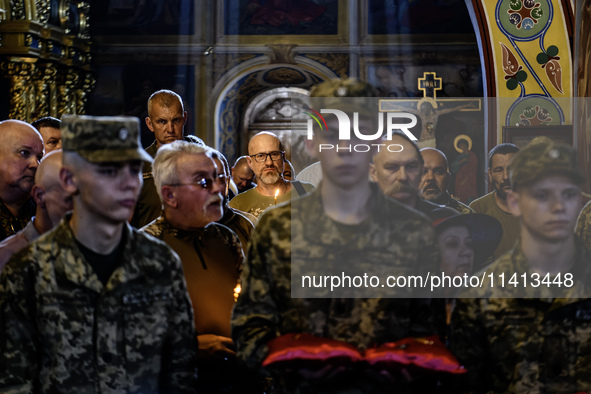 People are attending a funeral service for Mykola Kokhanivskyi, commander of the OUN (Organisation of Ukrainian Nationalists) volunteer batt...