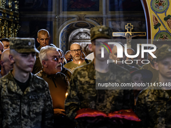 People are attending a funeral service for Mykola Kokhanivskyi, commander of the OUN (Organisation of Ukrainian Nationalists) volunteer batt...