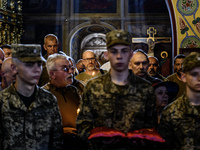 People are attending a funeral service for Mykola Kokhanivskyi, commander of the OUN (Organisation of Ukrainian Nationalists) volunteer batt...