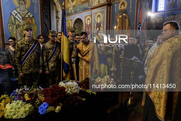 People are attending a funeral service for Mykola Kokhanivskyi, commander of the OUN (Organisation of Ukrainian Nationalists) volunteer batt...