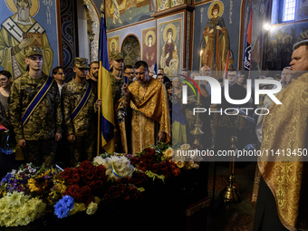 People are attending a funeral service for Mykola Kokhanivskyi, commander of the OUN (Organisation of Ukrainian Nationalists) volunteer batt...