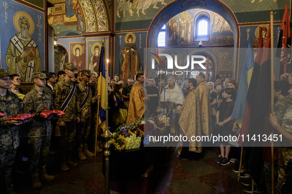 People are attending a funeral service for Mykola Kokhanivskyi, commander of the OUN (Organisation of Ukrainian Nationalists) volunteer batt...