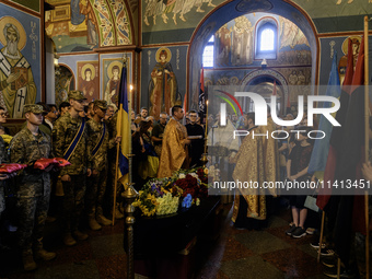 People are attending a funeral service for Mykola Kokhanivskyi, commander of the OUN (Organisation of Ukrainian Nationalists) volunteer batt...