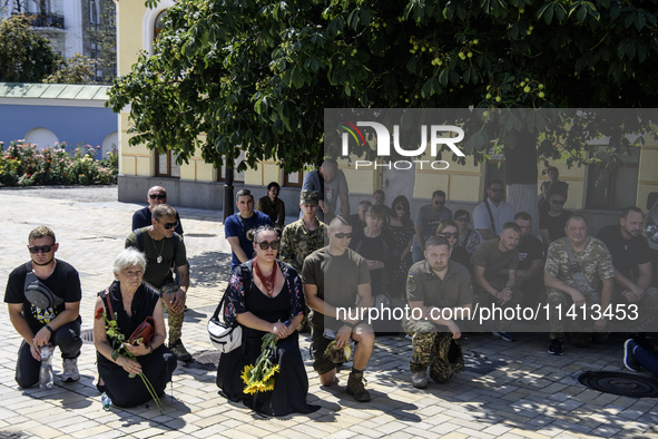 People are attending a funeral service for Mykola Kokhanivskyi, commander of the OUN (Organisation of Ukrainian Nationalists) volunteer batt...