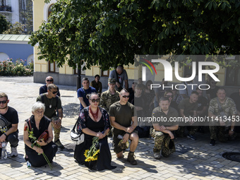 People are attending a funeral service for Mykola Kokhanivskyi, commander of the OUN (Organisation of Ukrainian Nationalists) volunteer batt...