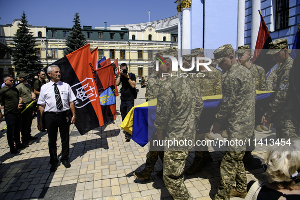 People are attending a funeral service for Mykola Kokhanivskyi, commander of the OUN (Organisation of Ukrainian Nationalists) volunteer batt...