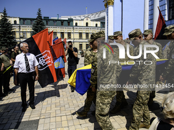 People are attending a funeral service for Mykola Kokhanivskyi, commander of the OUN (Organisation of Ukrainian Nationalists) volunteer batt...