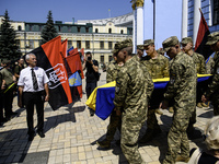 People are attending a funeral service for Mykola Kokhanivskyi, commander of the OUN (Organisation of Ukrainian Nationalists) volunteer batt...