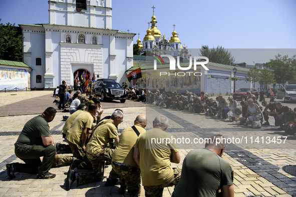 People are attending a funeral service for Mykola Kokhanivskyi, commander of the OUN (Organisation of Ukrainian Nationalists) volunteer batt...