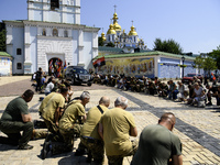 People are attending a funeral service for Mykola Kokhanivskyi, commander of the OUN (Organisation of Ukrainian Nationalists) volunteer batt...