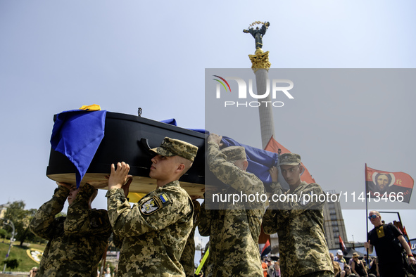 Servicemen are carrying the coffin of Mykola Kokhanivskyi, commander of the OUN (Organisation of Ukrainian Nationalists) volunteer battalion...