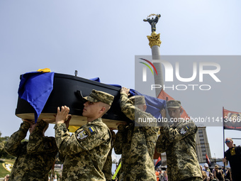 Servicemen are carrying the coffin of Mykola Kokhanivskyi, commander of the OUN (Organisation of Ukrainian Nationalists) volunteer battalion...