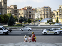 People are kneeling as the funeral procession for Mykola Kokhanivskyi, commander of the OUN (Organisation of Ukrainian Nationalists) volunte...