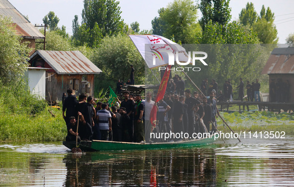 Kashmiri Shiite Muslim mourners are participating in a Muharram procession on a boat on the ninth day of Ashura in the interiors of Dal Lake...