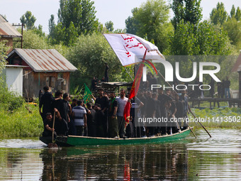 Kashmiri Shiite Muslim mourners are participating in a Muharram procession on a boat on the ninth day of Ashura in the interiors of Dal Lake...