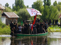 Kashmiri Shiite Muslim mourners are participating in a Muharram procession on a boat on the ninth day of Ashura in the interiors of Dal Lake...