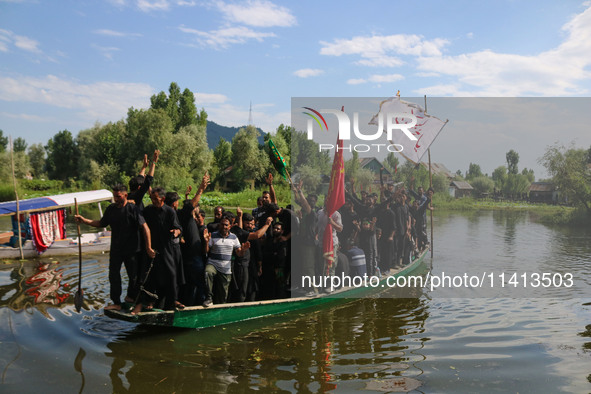 Kashmiri Shiite Muslim mourners are participating in a Muharram procession on a boat on the ninth day of Ashura in the interiors of Dal Lake...