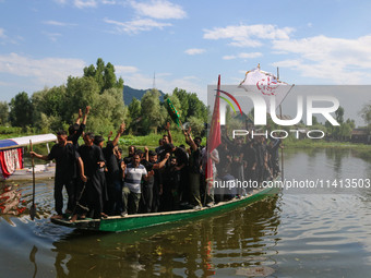 Kashmiri Shiite Muslim mourners are participating in a Muharram procession on a boat on the ninth day of Ashura in the interiors of Dal Lake...