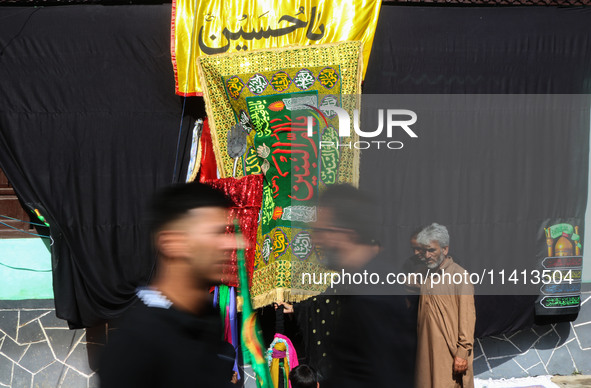 Kashmiri Shiite Muslim mourners are participating in a Muharram procession on the ninth day of Ashura in the interiors of Dal Lake in Srinag...