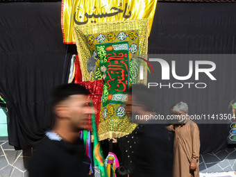 Kashmiri Shiite Muslim mourners are participating in a Muharram procession on the ninth day of Ashura in the interiors of Dal Lake in Srinag...