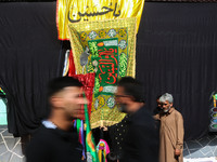 Kashmiri Shiite Muslim mourners are participating in a Muharram procession on the ninth day of Ashura in the interiors of Dal Lake in Srinag...