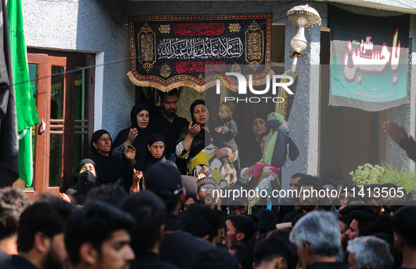 Kashmiri Shiite Muslim mourners are participating in a Muharram procession on the ninth day of Ashura in the interiors of Dal Lake in Srinag...