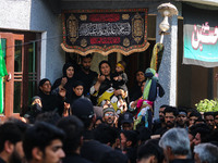 Kashmiri Shiite Muslim mourners are participating in a Muharram procession on the ninth day of Ashura in the interiors of Dal Lake in Srinag...