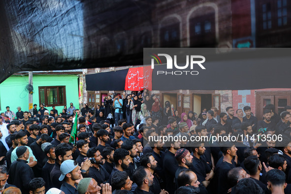 Kashmiri Shiite Muslim mourners are participating in a Muharram procession on the ninth day of Ashura in the interiors of Dal Lake in Srinag...