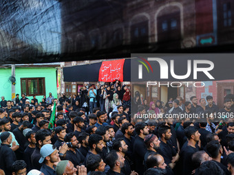 Kashmiri Shiite Muslim mourners are participating in a Muharram procession on the ninth day of Ashura in the interiors of Dal Lake in Srinag...