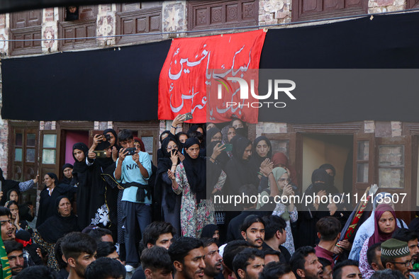 Kashmiri Shiite Muslim mourners are participating in a Muharram procession on the ninth day of Ashura in the interiors of Dal Lake in Srinag...