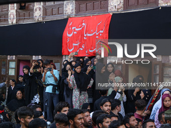 Kashmiri Shiite Muslim mourners are participating in a Muharram procession on the ninth day of Ashura in the interiors of Dal Lake in Srinag...