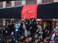 Kashmiri Shiite Muslim mourners are participating in a Muharram procession on the ninth day of Ashura in the interiors of Dal Lake in Srinag...