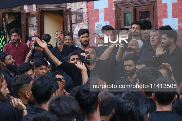 Kashmiri Shiite Muslim mourners are participating in a Muharram procession on the ninth day of Ashura in the interiors of Dal Lake in Srinag...